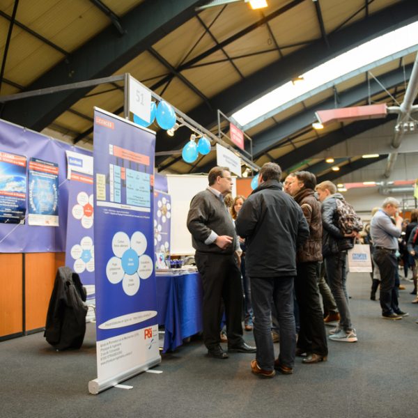 STRASBOURG, FRANCE - FEB 4, 2016: Children and teens of all ages attending annual Education Fair to choose career path and receive vocational counseling - busy stand